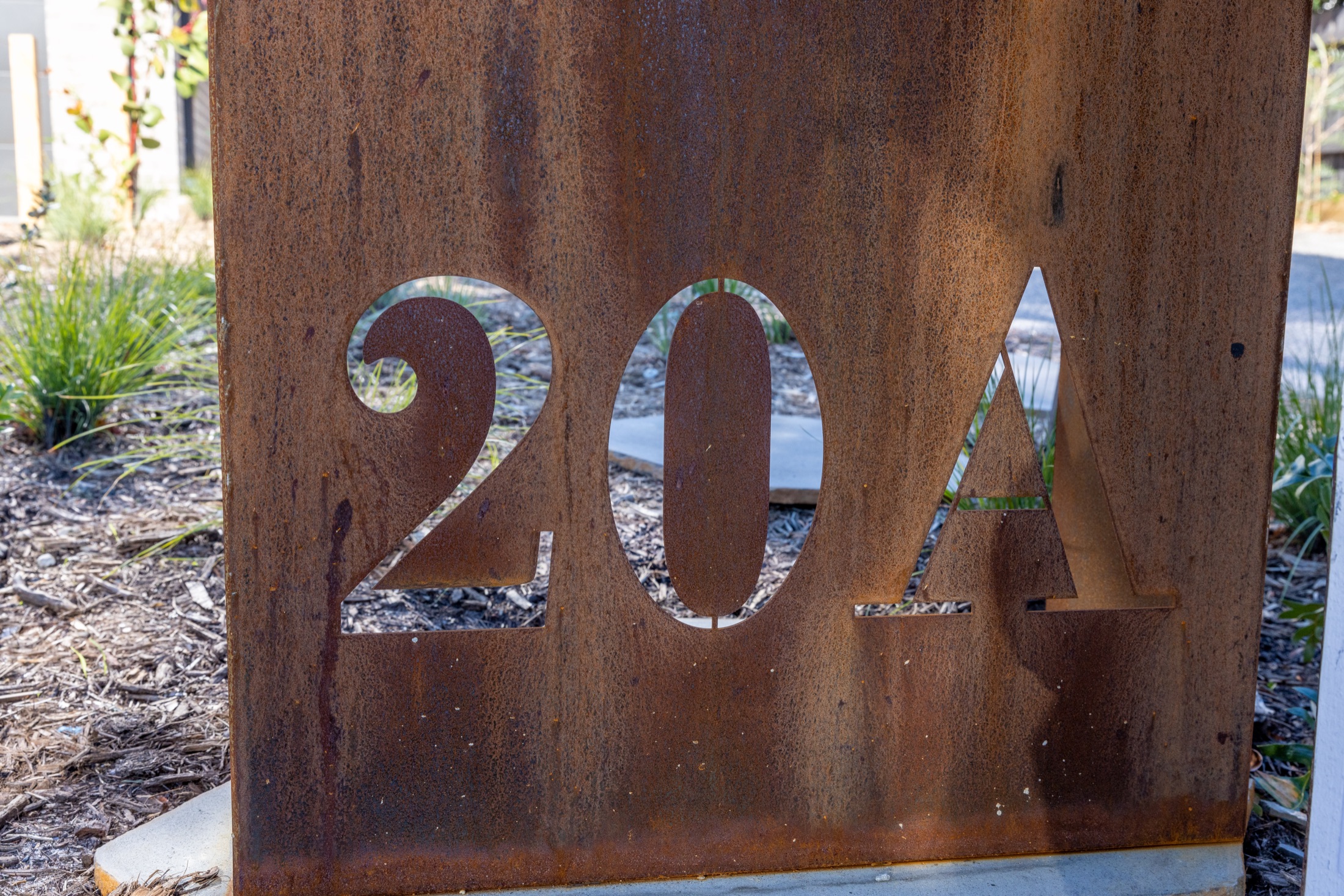 Corten steel 20A street number set within the front garden