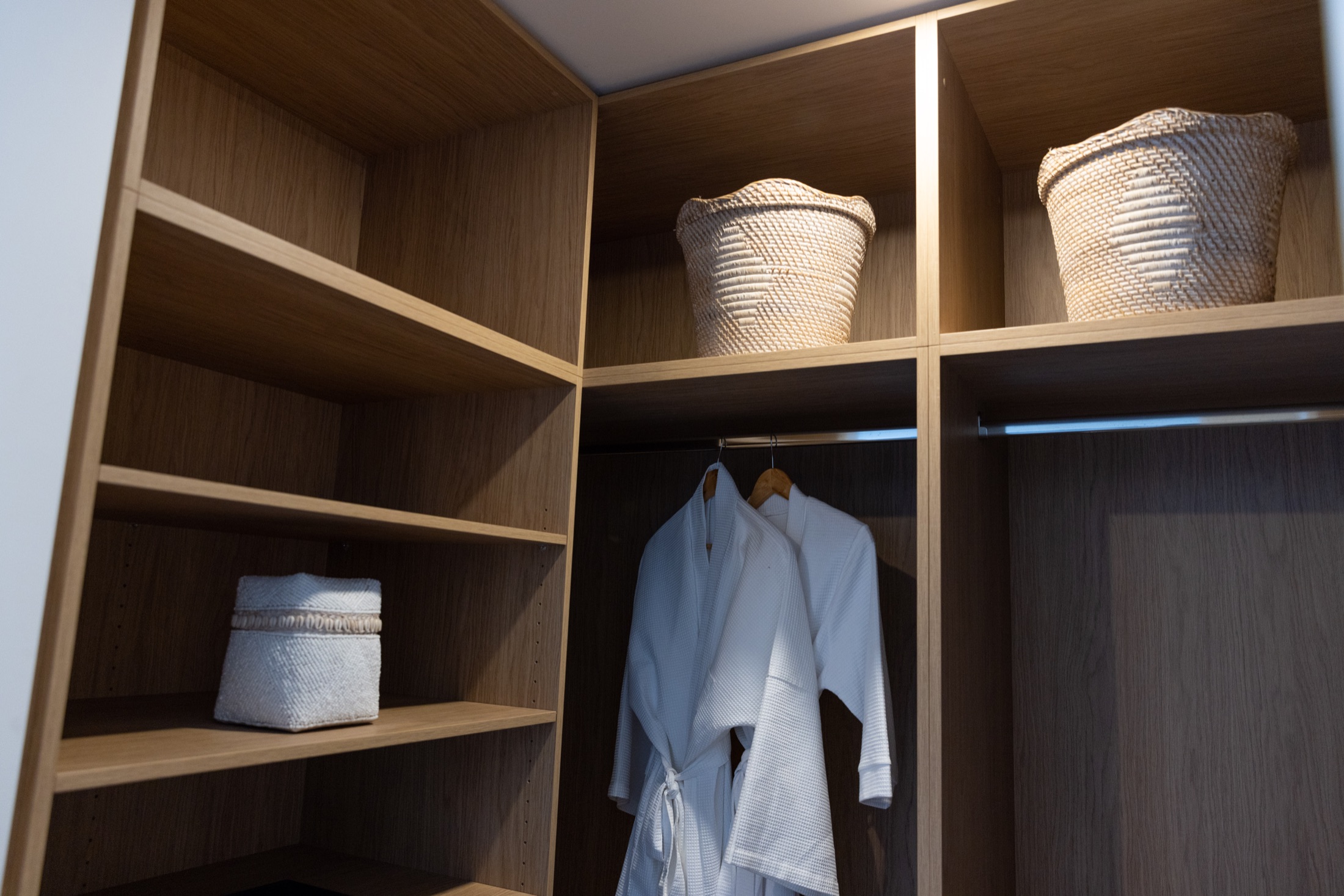 Built-in timber wardrobe joinery with open shelving and hanging space