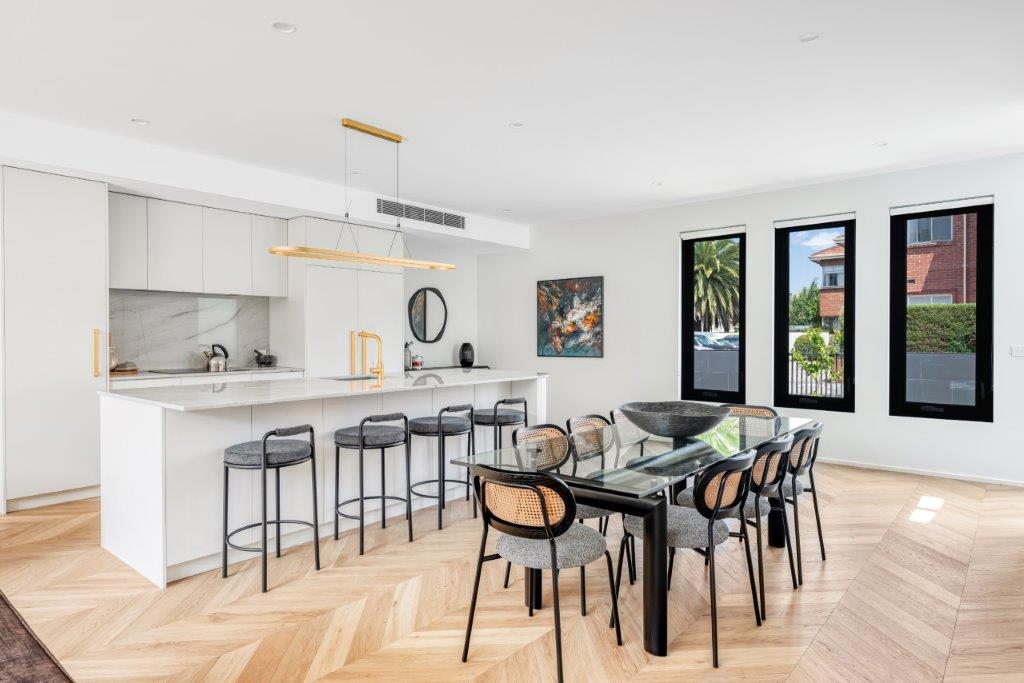 Kitchen and dining at Barkly Street with a marble island and a gold pendant