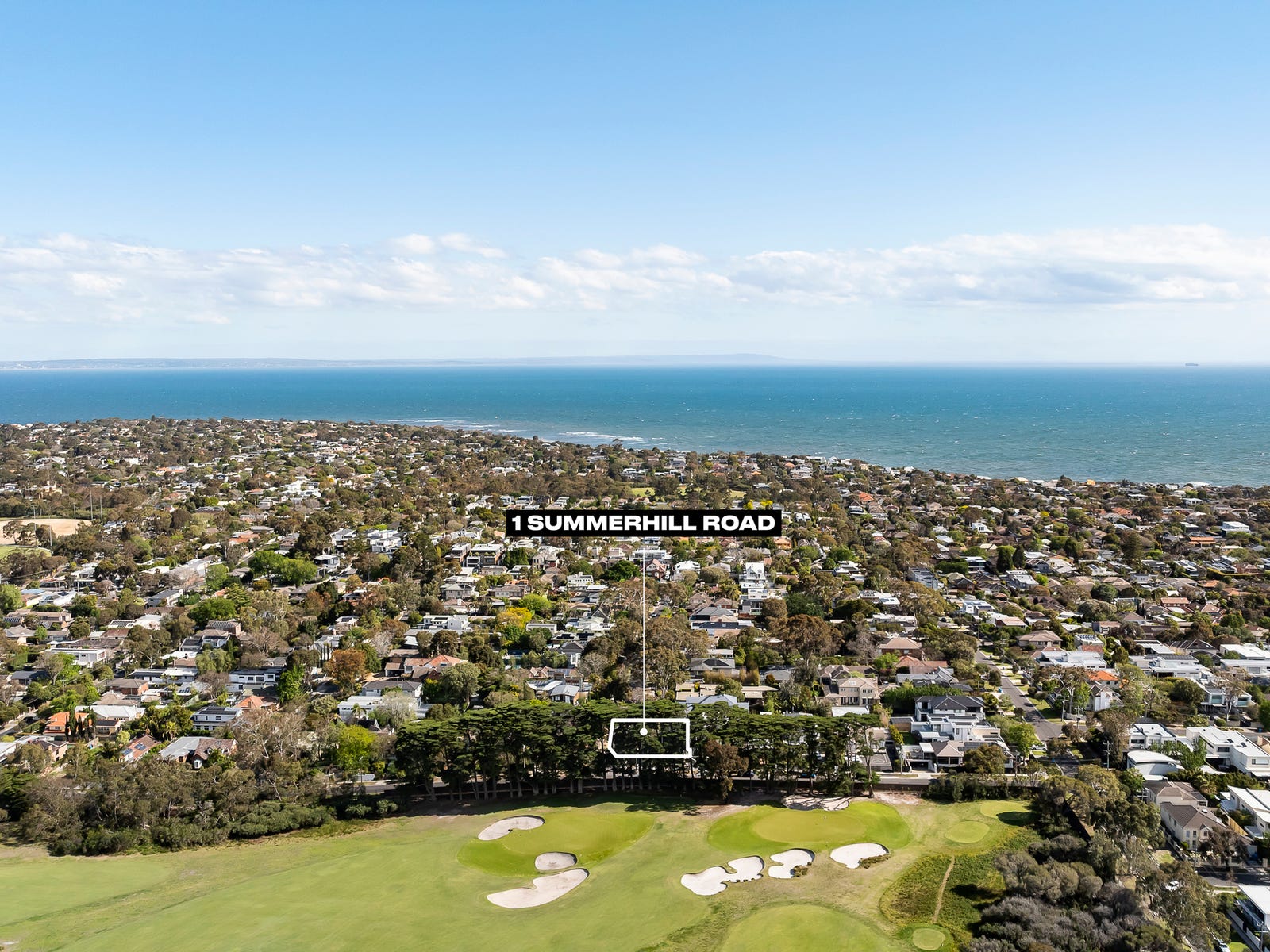 Aerial over Beaumaris with 1 Summerhill Road marked, golf course and bay beyond